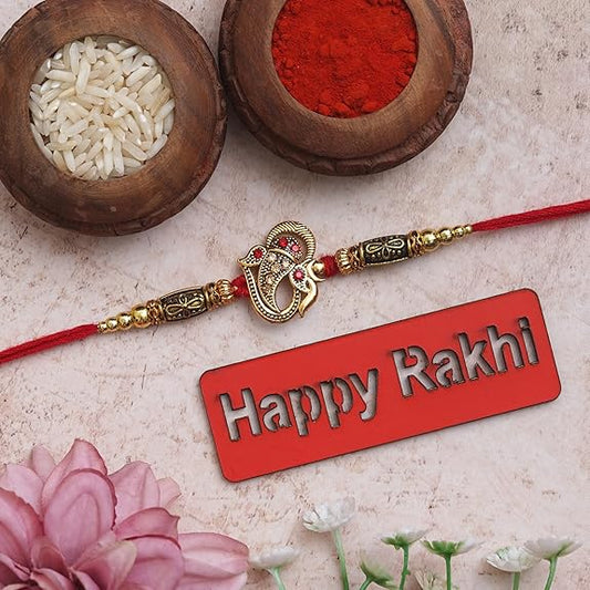 Fashtales Handicrafts Golden Beads, Om Symbol Religious Designer Rakhi with Roli Chawal Pack and Happy Rakhi Wooden Cutout