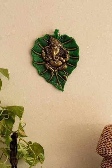 Ganesh ji sits on green color pipal leaf wall hanging for home, office, temple, room decor 20cm (metal, gold & green) handmade