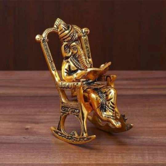 Ganesh sitting on chair reading Idol for home, office, temple, gifting purpose, decorative showpiece- 15cm (metal,gold) handmade
