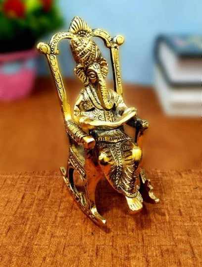 Ganesh sitting on chair reading Idol for home, office, temple, gifting purpose, decorative showpiece- 15cm (metal,gold) handmade