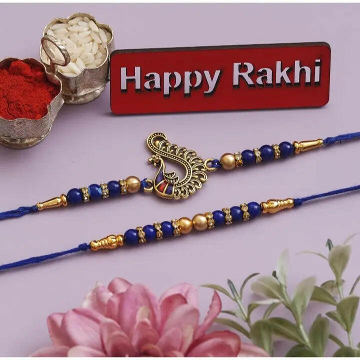 Fashtales Handicrafts Set of 2 Blue & Golden Pearls and Peacock Designer Rakhis with Roli Chawal Pack and Happy Rakhi Wooden Cutout - Rakhi for Brother, Bhaiya, Bhai